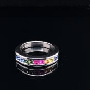 AN 18ct WHITE GOLD MULTI SAPPHIRE CHANNEL SET RING. THE NINE PRINCESS CUT SAPPHIRES IN AN ARRAY OF