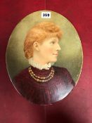 AN OVAL PORTRAIT ON PORCELAIN OF A RED HAIRED LADY WEARING A WINE RED DRESS WITH A WHITE RUFF LIKE