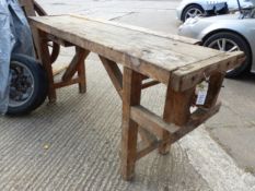 A RUSTIC PINE WORK BENCH.