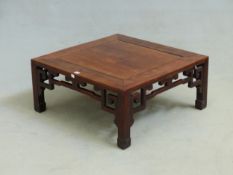 AN ANTIQUE CHINESE CARVED ROSEWOOD LOW SQUARE TABLE, PIERCED APRON. W. 76 x H. 35cms.