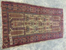 AN ANTIQUE CAUCASIAN DESIGN RUG