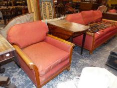 A THREE PIECE BERGERE SUITE NOW UPHOLSTERED IN TERRACOTTA, THE BUN LEGS TO THE FRONTS ON BRASS