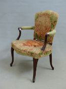 A 19th C. MAHOGANY ELBOW CHAIR, THE SERPENTINE TOPPED BACK AND FRONTED SEAT UPHOLSTERED IN GREEN