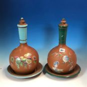 ATTRIBUTED TO WATCOMBE, TWO SIMILAR TERRACOTTA WATER BOTTLES, COVERS AND STANDS DECORATED WITH A