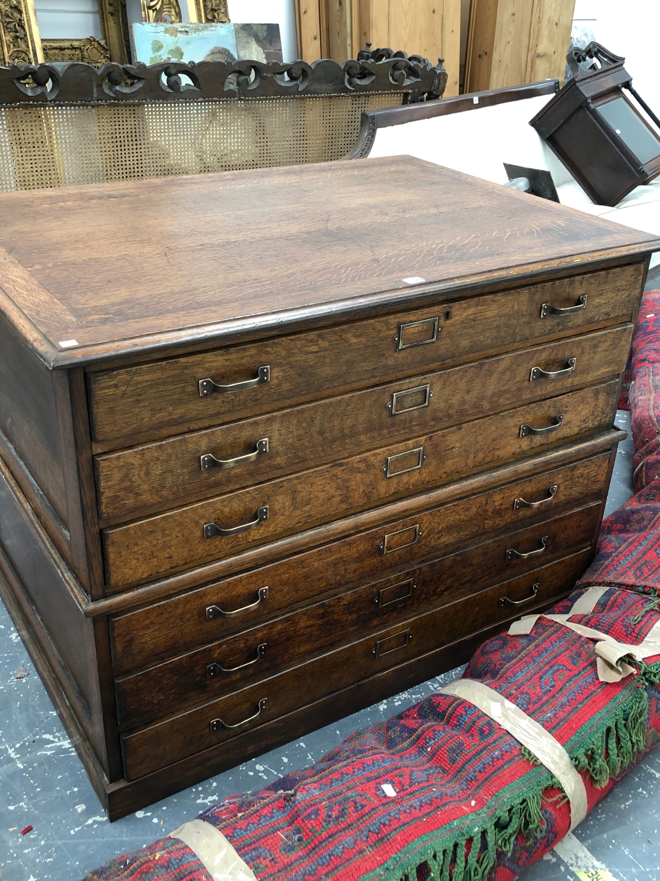 A VINTAGE OAK CHART OR PLAN CHEST OF TWO HALVES EACH WITH THREE LONG DRAWERS, THE BASE HALF WITH