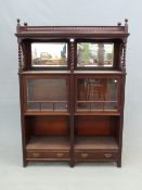 AN ARTS AND CRAFTS MORRIS STYLE MAHOGANY DISPLAY CABINET, THE TOP SHELF WITH BEVELLED GLASS MIRROR