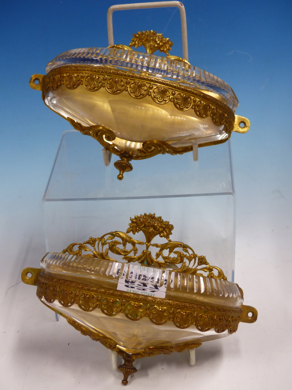 A PAIR OF FRENCH GILT METAL AND CUT GLASS WALL POCKETS, THE HALF ROUND FRONTS CAST WITH ANTHEMION