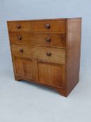 A 19th C. MAHOGANY CHEST OF TWO SHORT AND TWO LONG DRAWERS OVER A CUPBOARD AND THE PLINTH FOOT. W