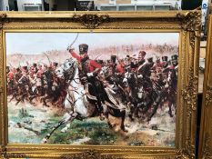 A LARGE DECORATIVE PICTURE DEPICTING CAVALRY AT WATERLOO IN SWEPT GILT FRAME. THE FRAME 221 x