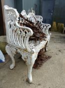 A CAST IRON GARDEN BENCH IN THE COALBROOKDALE TASTE, THE BACK WITH SERPENTINE FOLIATE TOP RAIL ABOVE