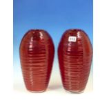 A PAIR OF RUBY GLASS OVOID VASES HORIZONTALLY TRAILED IN POWELL STYLE. H 28cms.