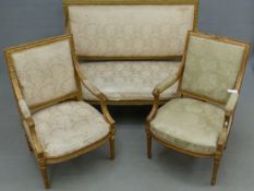 A LOUIS XVI TASTE GILT GESSO THREE PIECE SUITE, THE UPHOLSTERED RECTANGULAR BACKS AND SEATS ENCLOSED