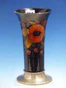 A MOORCROFT POMEGRANATE PATTERN TRUMPET SHAPED VASE ON TUDRIC HAMMERED PEWTER SPREADING FOOT. H 22.