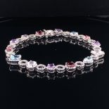 AN 18ct WHITE GOLD DIAMOND AND MULTI GEMSET BRACELET. INDIVIDUALLY DIAMOND HALO SET WITH FOURTEEN