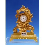 A WATCH MOVEMENT MOUNTED IN ROCOCO ORMOLU FRAME RESTING ON A RECTANGULAR PLINTH WITH FOUR FEET. H