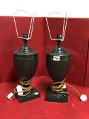 A PAIR OF BRONZE FLUTED URN SHAPED TABLE LAMPS ON SQUARE FEET. H 38cms.