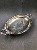 A CONTINENTAL SILVER OVAL FORM FOOTED SHALLOW DISH WITH ORNATE SERVING HANDLES. WIDTH 35.5grms,