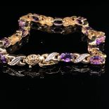 A 9ct AMETHYST AND DIAMOND BRACELET. LENGTH 18.5cms.