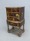 A CHINOISERIE SIMULATED LACQUER SIDE CABINET WITH A BRUSHING SLIDE ABOVE A CONFIGURATION OF FIVE