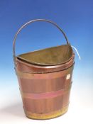 A MAHOGANY OVAL SECTIONED BUCKET COOPERED BY THREE BRASS BANDS, A HANDLE OVERSWINGING THE