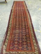 AN ANTIQUE PERSIAN TRIBAL RUNNER, 430 X 115cm.