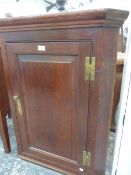 A GEORGE III OAK CORNER CABINET.