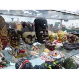 A QUANTITY OF VARIOUS AFRICAN AND EASTERN MASKS.