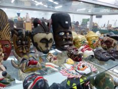 A QUANTITY OF VARIOUS AFRICAN AND EASTERN MASKS.