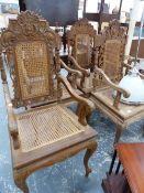 A SET OF OUR CARVED HARDWOOD ARMCHAIRS WITH CANE PANEL SEATS AND BACKS.