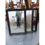 THREE EBONISED SWEPT FRAME BEVEL EDGE MIRRORS. 107 x 77cms (3).