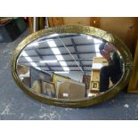 A LARGE ART DECO BRASS FRAMED OVAL BEVEL EDGE MIRROR, 100 x 64cms. TOGETHER WITH FOUR OTHER