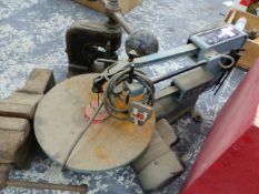 A BENCHTOP JIGSAW, A FLY PRESS, AND A BENCH VICE.