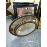 A PAIR OF EBONISED SWEPT FRAME BEVEL EDGE MIRRORS. 90 x 65cms. TOGETHER WITH TWO VINTAGE OAK OVAL