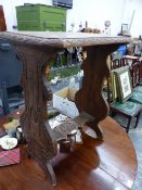 A SMALL CARVED OAK OCCASIONAL TABLE.