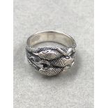 A SILVER TRIPLE COILED SERPENT RING FINGER SIZE V.
