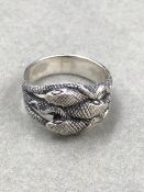 A SILVER TRIPLE COILED SERPENT RING FINGER SIZE V.