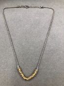 A SILVER AND GILDED WOVEN NECKLET, LENGTH 45cms.