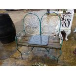 A PAINTED WROUGHT IRON GARDEN BENCH.