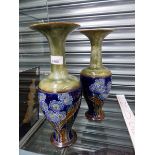 A PAIR OF ROYAL DOULTON POTTERY TALL VASES WITH FLARED RIMS AND FLOWER DECORATION.