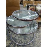 A CHROME AND GLASS RETRO FOUR TIER TABLE.