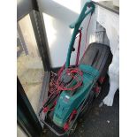 A BOSCH ELECTRIC LAWN MOWER AND STRIMMER.