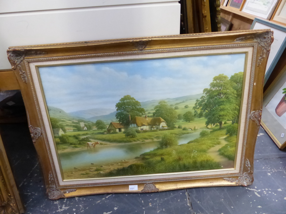 A DECORATIVE PICTURE OF A RURAL VILLAGE BY A RIVER, SIGNED GARY MILLER. 51 x 76cms.