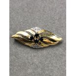 A 9ct GOLD VINTAGE SAPPHIRE AND DIAMOND STYLISED BROOCH. MEASUREMENTS L 3.6cms x 1.5cms, WEIGHT 3.