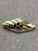 A 9ct GOLD VINTAGE SAPPHIRE AND DIAMOND STYLISED BROOCH. MEASUREMENTS L 3.6cms x 1.5cms, WEIGHT 3.