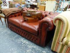 A BUTTON LEATHER UPHOLSTERED TWO SEAT CHESTERFIELD SOFA BED.