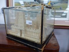 A PITH MODEL OF A TEMPLE IN A GLAZED CASE.