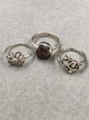 THREE SILVER RINGS, INTERLOCKING HEARTS, STONE SET DAISY AND AN AMETHYST GEODE EXAMPLE. SIZES N, O