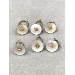 A SET OF SIX 9ct GOLD AND MOTHER OF PEARL SUIT BUTTONS. GROSS WEIGHT 10.1grms.