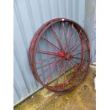 A PAIR OF VINTAGE CAST IRON WAGON WHEELS.