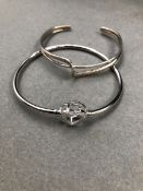 TWO SILVER BANGLES. A STONE SET HEART BANGLE AND A CUFF BANGLE. GROSS WEIGHT 21.5grms.